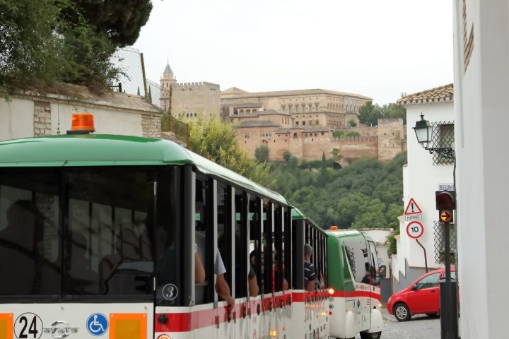 a passenger bus that is parked on the side of the road